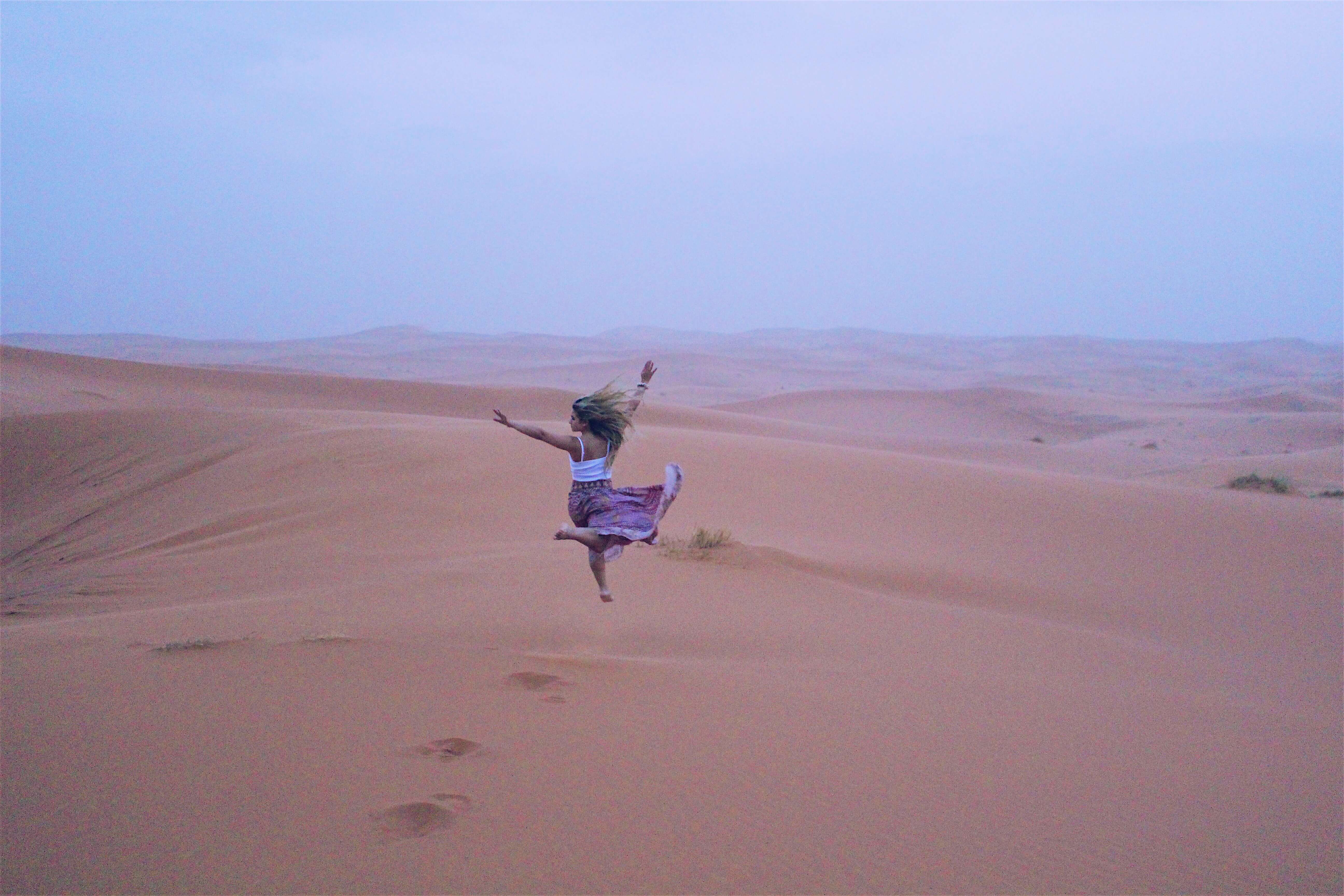 Sahara desert Morocco girl jumping